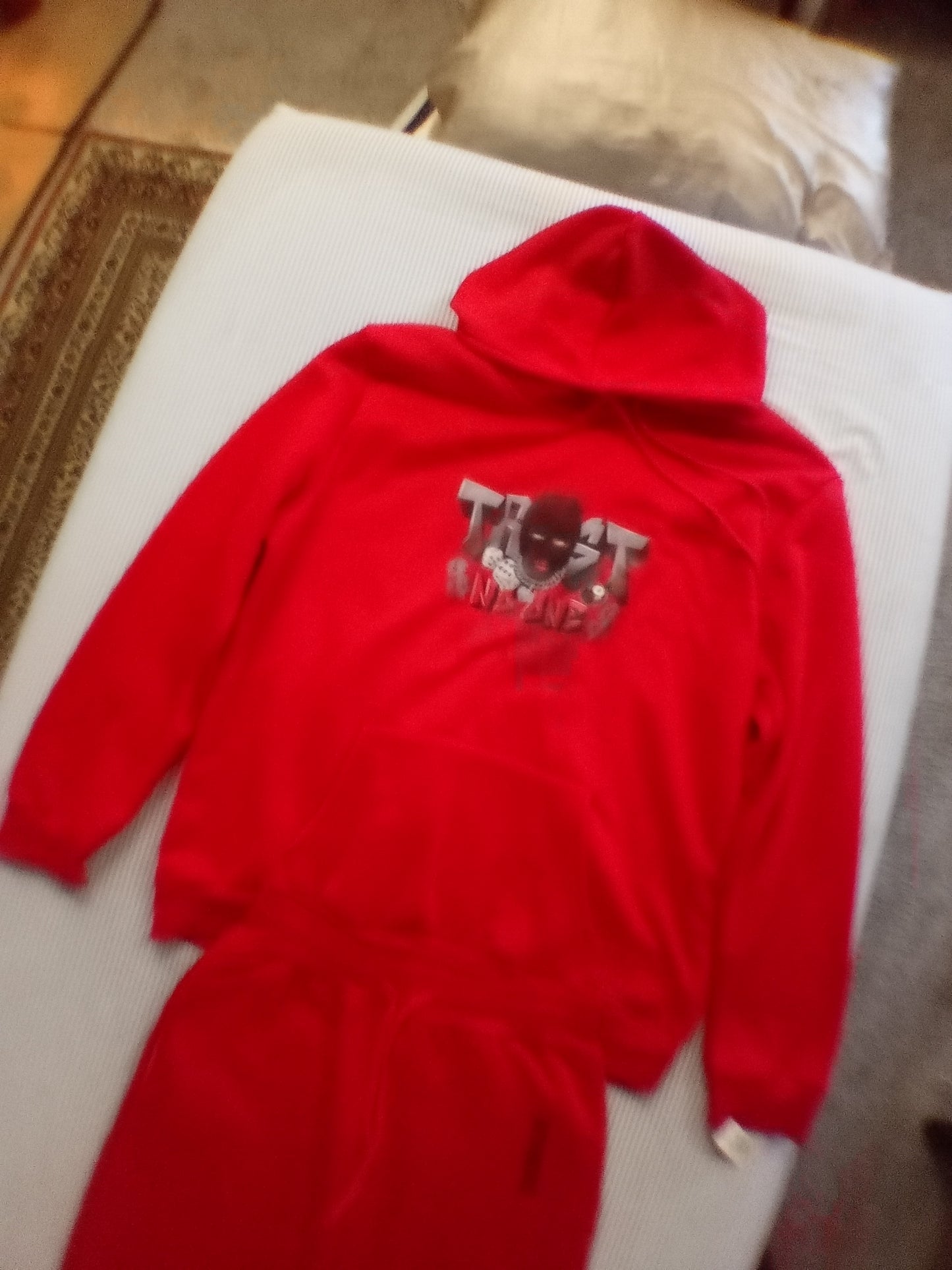 Red trust no one track suit